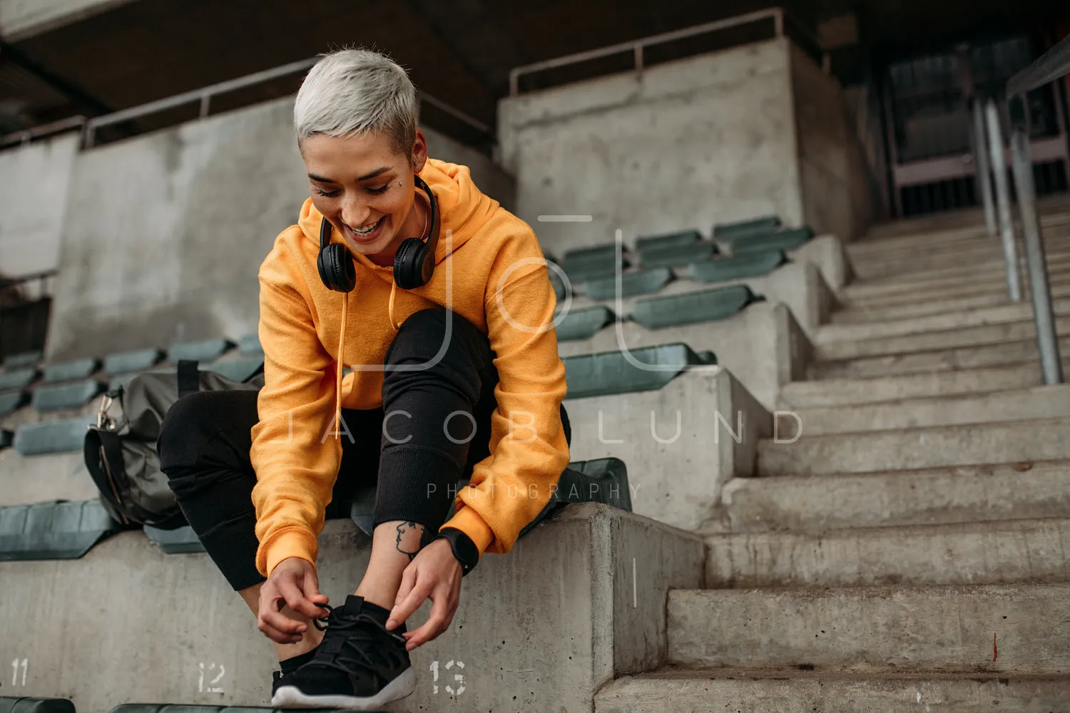 Cheerful female athlete wearing her shoes